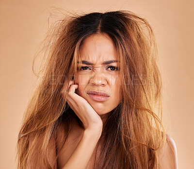 Buy stock photo Face portrait, hair loss and sad woman in studio isolated on a brown background. Salon, keratin damage and angry female model with haircare problem, messy hairstyle or split ends after treatment fail