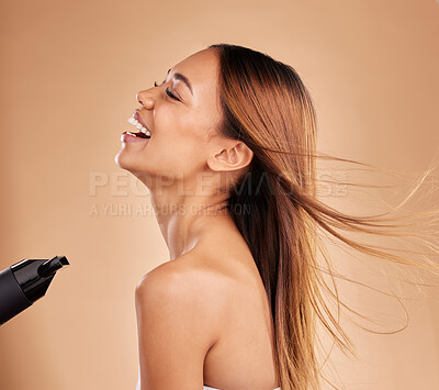 Buy stock photo Beauty, woman and hair care with hairdryer in studio for growth or shine with strong texture. Happy aesthetic female laugh using blow dryer and heat protect for health and color on a brown background