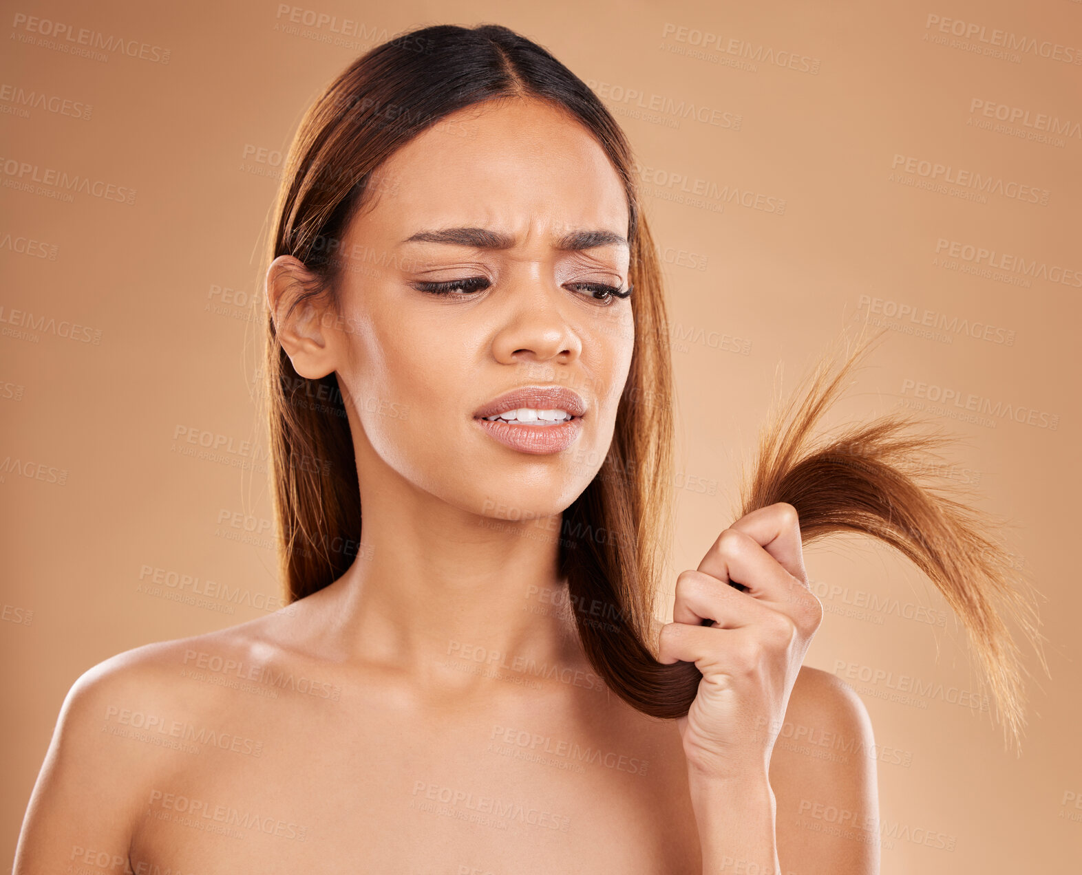 Buy stock photo Hair care, frustrated and a woman looking at split ends isolated on a studio background. Unhappy, frizzy and a girl with a problem with damaged, tangled and breakage of a hairstyle on a backdrop