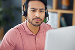 Serious asian man, call center and computer with headphones for customer service, help or support at office. Focused male consultant or agent with headset on PC for telemarketing or online advice