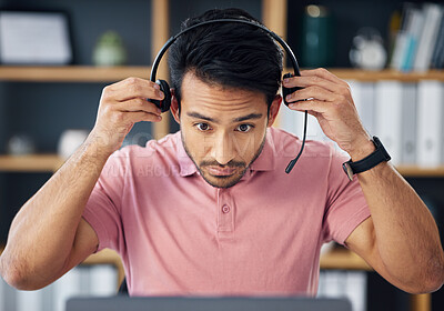 Buy stock photo Asian man, call center and headset on laptop ready for consulting, customer service or support at office desk. Serious male consultant putting on headphones by computer for telemarketing or advice
