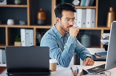 Buy stock photo Serious asian man, thinking and computer for digital marketing, project planning or schedule at office desk. Male creative designer in thought working on PC and laptop for market or startup strategy