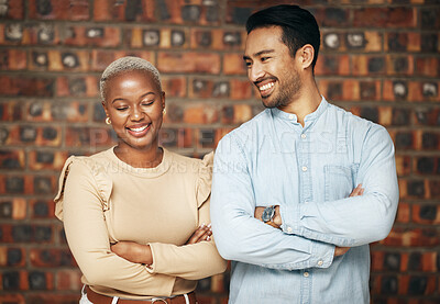 Buy stock photo Happy, professional team and partnership, collaboration with smile and arms crossed with friends against brick wall. Work together, employees and diversity, black woman and man, teamwork and trust