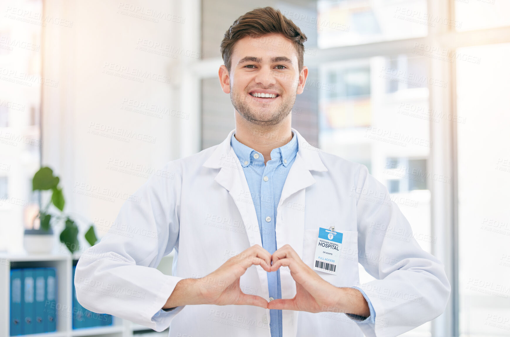 Buy stock photo Hands in heart, doctor and portrait of man in hospital with sign for wellness, medicine and medical care. Healthcare, insurance and happy worker in clinic for consulting, trust and cardiology support