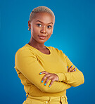 Portrait, fashion and arms crossed with a black woman on a blue background in studio feeling confident. Serious, focus or empowerment and an attractive young female looking proud with confidence
