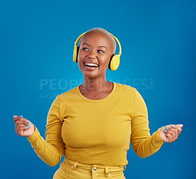 Buy stock photo Black woman with headphones, dancing and listen to music, rhythm and fun with freedom on blue background. Happy female with yellow aesthetic, streaming radio with dance and carefree in studio