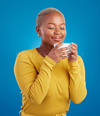 Buy stock photo Coffee, aroma and a black woman on a blue background in studio smelling the scent for her mug. Relax, drink and easy with an attractive young female enjoying a fresh cup of caffeine during a break