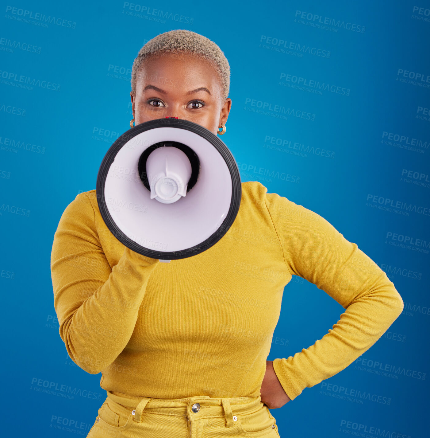 Buy stock photo Megaphone, protest and speaker with black woman in studio for change, democracy and opinion. Vote, announcement and message with female isolated on blue background for empowerment, strike and choice