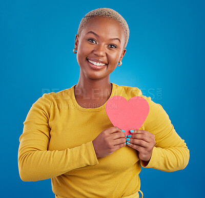 Buy stock photo Paper heart, happy black woman and portrait in studio, blue background and backdrop. Smile, female model and shape for love, wellness and support of peace, thank you and kindness on valentines day 