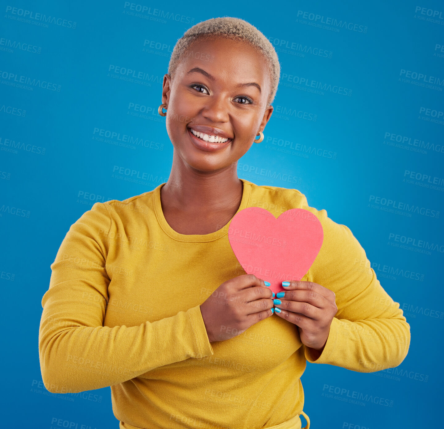 Buy stock photo Paper heart, happy black woman and portrait in studio, blue background and backdrop. Smile, female model and shape for love, wellness and support of peace, thank you and kindness on valentines day 