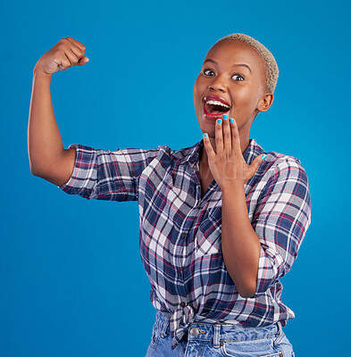Shocked, arm flex and portrait of black woman in studio for empowerment, confident or success. Achievement, hard work and pride with female isolated on blue background for power, strong or motivation