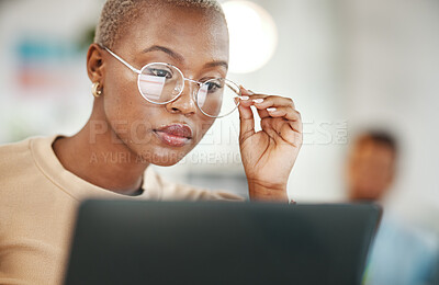 Buy stock photo Office, computer and black woman with glasses, serious or reading email, online research or report. Laptop, concentration and African journalist proofreading article for digital news website or blog