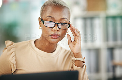 Buy stock photo Laptop, serious and black woman with glasses, reading email or online research report in office. Computer, concentration and African journalist proofreading article for digital news website or blog.