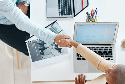 Buy stock photo Creative business people, handshake and laptop above on mockup screen for teamwork collaboration at office. Top view of employee designers shaking hands for meeting, partnership or startup agreement