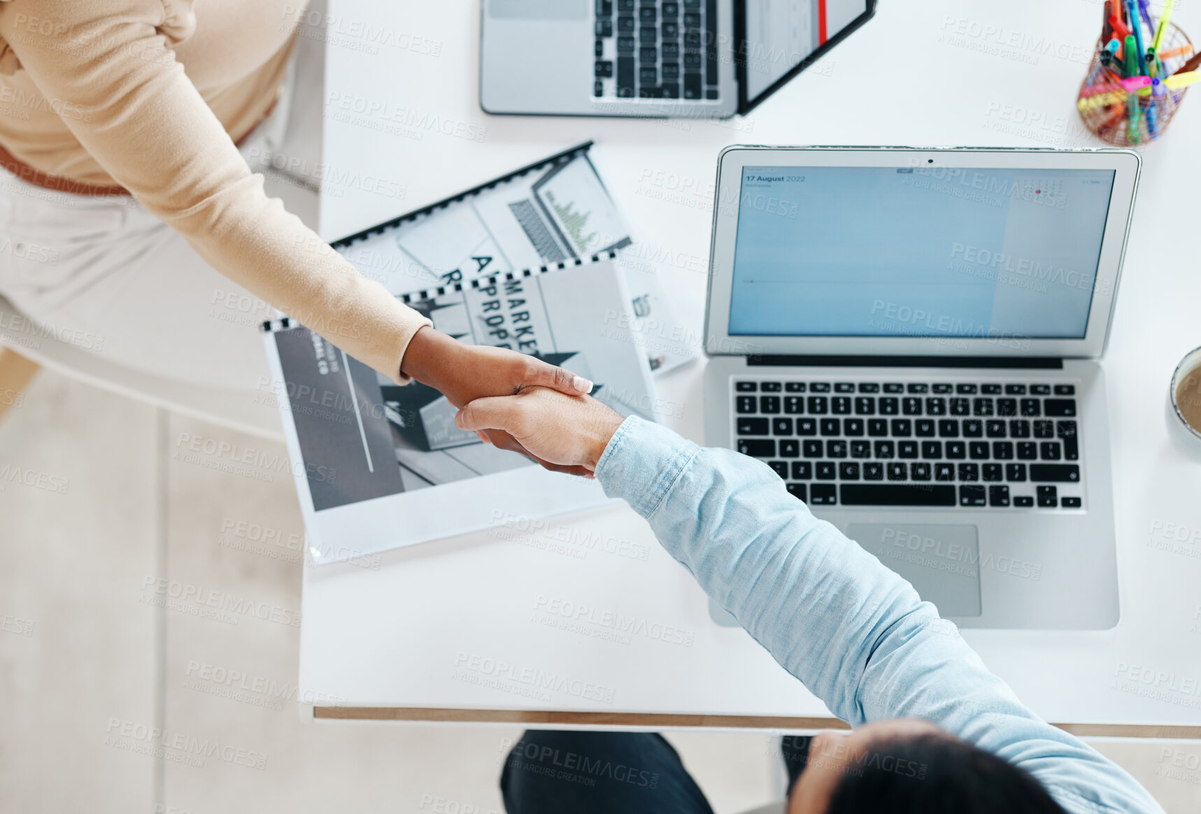 Buy stock photo Creative business people, handshake and laptop above on mockup screen for teamwork collaboration at office. Top view of employee designers shaking hands for meeting, partnership or startup agreement