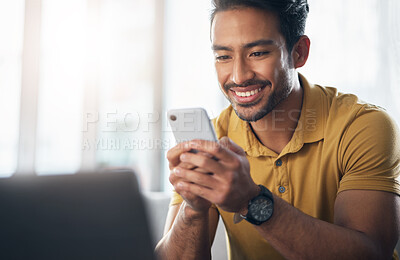 Buy stock photo Happy asian man, phone and smile for social media, communication or networking at home. Male freelancer smiling on mobile smartphone app for chatting, texting or browsing on internet or research