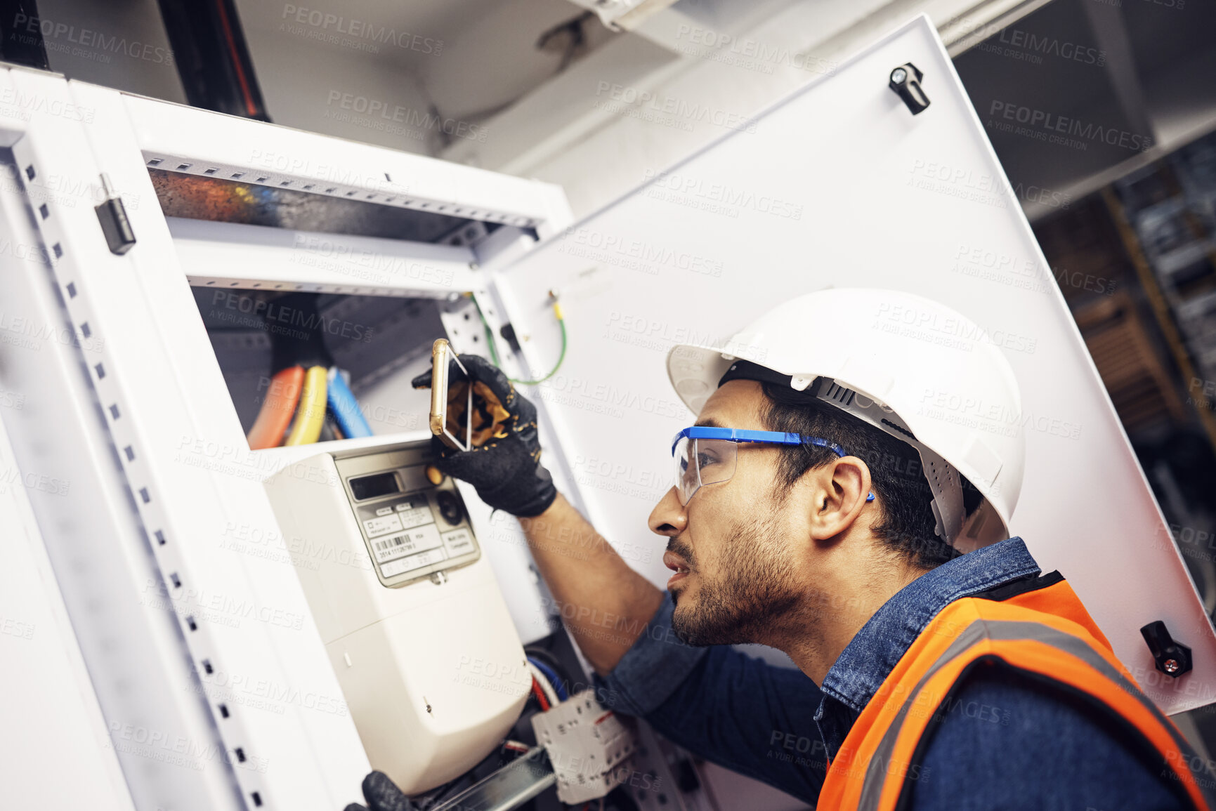 Buy stock photo Man, phone and technician in electric inspection for power or sustainable energy at work site. Male electrician, contractor or engineer with smartphone looking to inspect electricity on circuit board