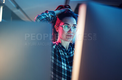 Buy stock photo Cybersecurity, malware and woman hacker working on a computer in the basement at night for phishing. Database, password and ransomware with a female coder hacking a digital transformation network