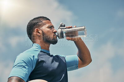 Buy stock photo Drinking water, fitness and training with a sports man outdoor for a competitive game or event. Exercise, hydration and health with a male athlete taking a drink from a bottle during a break or rest