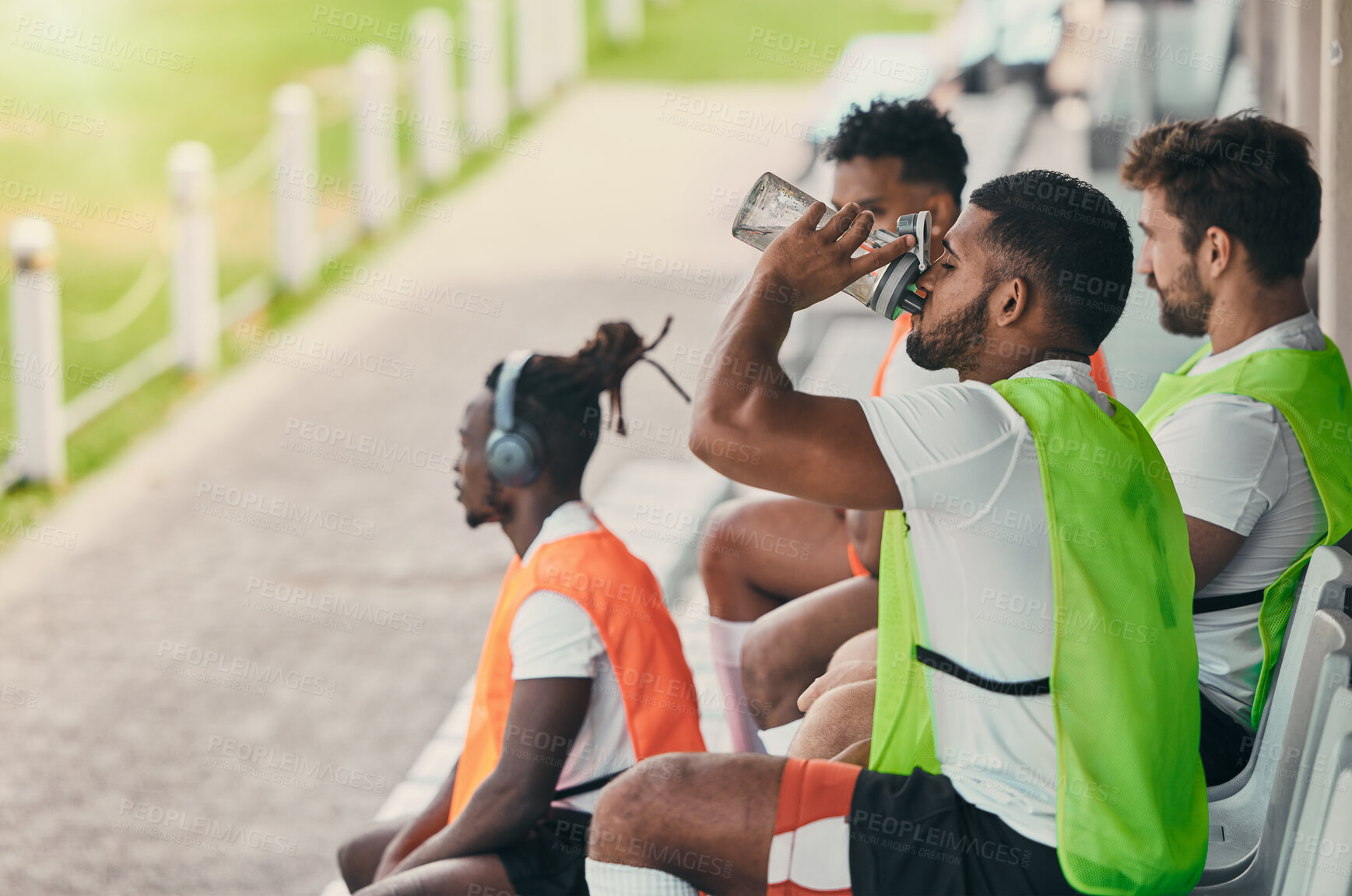 Buy stock photo Team, rugby men and fitness on bench with drinking water, relax or sitting with diversity, solidarity or health. Group teamwork, university or professional sports at stadium for game, friends or goal