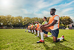 Sports, training and team outdoor for rugby on a grass field with men doing knee exercise. Athlete group together for fitness and workout for professional sport with diversity, support and teamwork