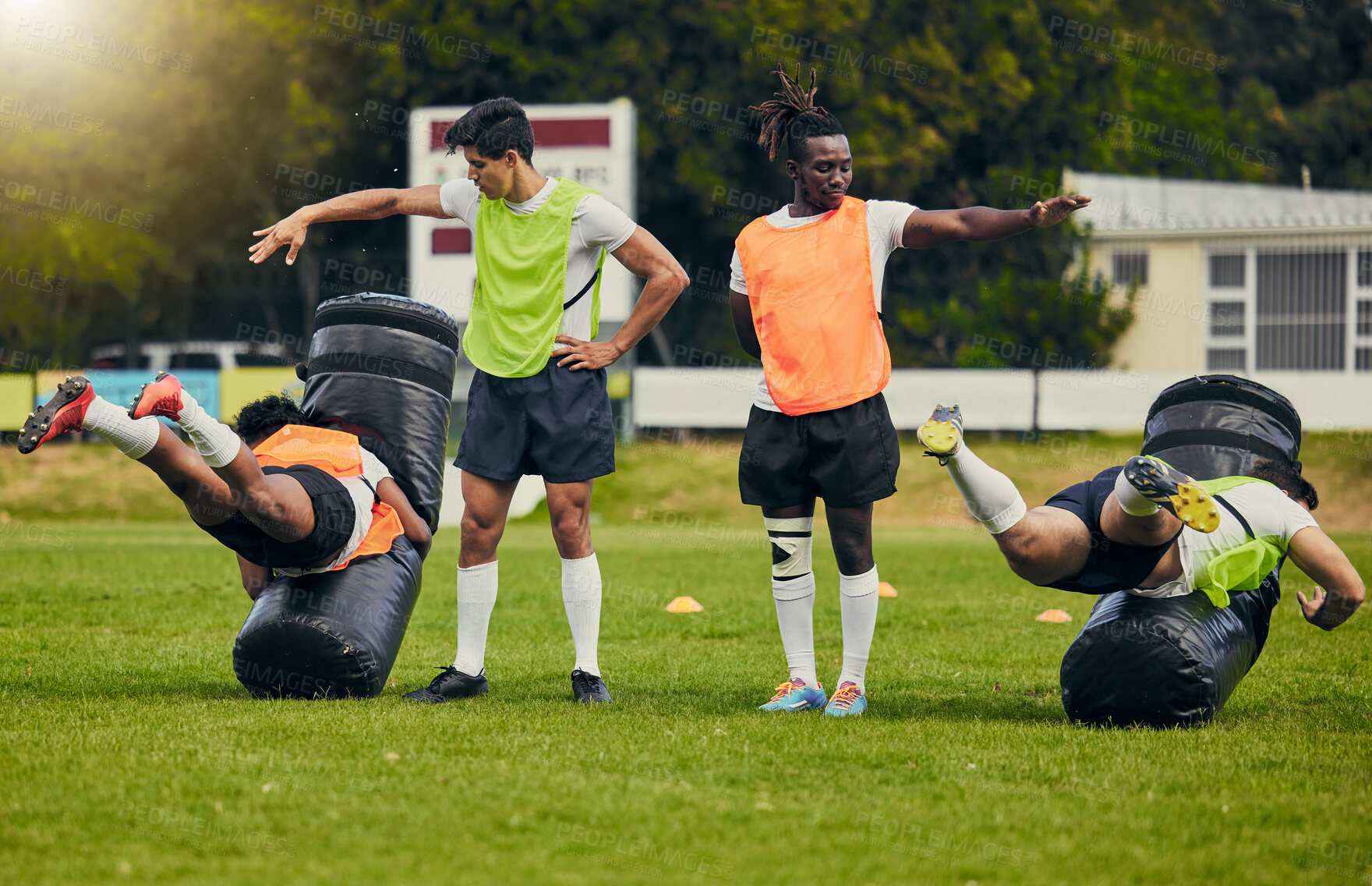 Buy stock photo Rugby, tackle and men training on field with equipment ready for match, practice and sport games. Fitness, teamwork and male athletes for warm up performance, exercise and workout for competition