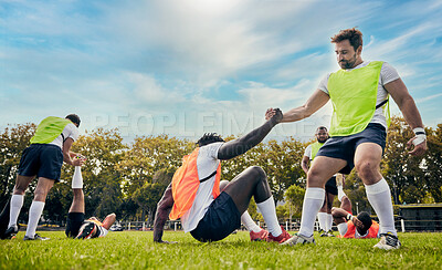 Buy stock photo Teamwork, helping hand or rugby men in training, exercise or workout in practice match on grass field. Challenge, strong man or powerful group in tough competitive sports game with physical fitness 