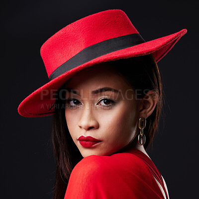 Buy stock photo Portrait, red and fashion with a woman on a dark background in studio rich or wealthy style. Face, elegant and classy with an attractive young female model posing in modern designer clothes