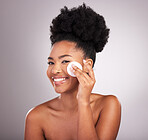 Black woman, cotton and skincare in studio with cleaning, makeup removal and happy by background. Young model, wipe or wipe to clean face for natural glow, wellness and cosmetic health with self care