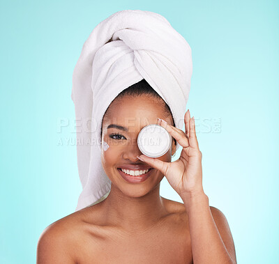 Buy stock photo Black woman, jar and skin cream in studio portrait with smile for skincare, wellness or self care by blue background. Girl, african and model with product by eye for natural glow, beauty or cosmetics