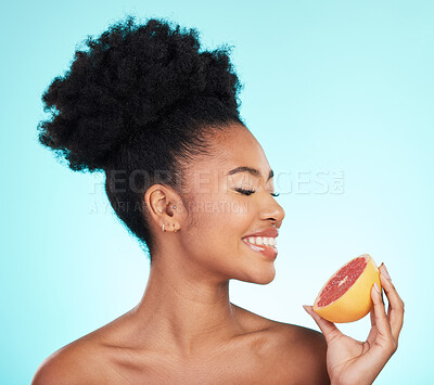 Buy stock photo Grapefruit, skincare and woman smile with fruit for beauty, wellness and detox healthcare. Isolated, blue background and studio with a young female feeling happy from healthy food with vitamin c