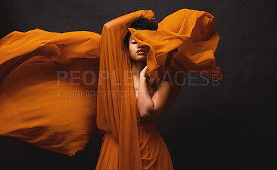Buy stock photo Black woman, art and fashion, fabric movement on dark background with beauty and aesthetic motion. Flowing silk, fantasy and artistic, serious African model in brown creative designer dress in studio