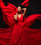 Black woman, art and fashion, red fabric on dark background with motion and aesthetic movement. Flowing silk, fantasy and artistic beauty, sensual African model in creative designer dress in studio.