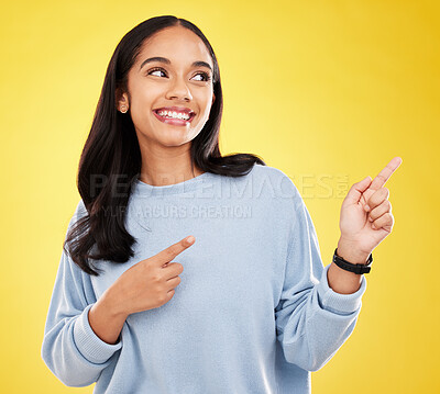 Buy stock photo Yellow background, point and face of woman with smile for advertising, promotion and announcement. Mockup space, studio and isolated happy girl with hand gesture for information, discount or news