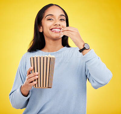 Buy stock photo Woman is eating popcorn, happiness and portrait with snack for watching tv or movie on yellow studio background. Streaming service, film and food with corn treat, young female with smile and cinema