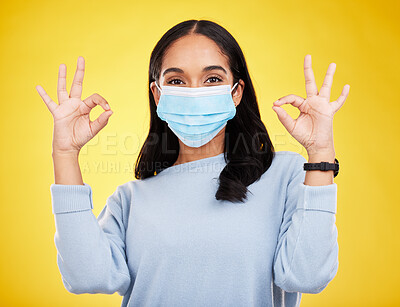 Buy stock photo Covid, okay sign and portrait of woman in studio for positive, illness and approval. Protection, prevention and disease with female isolated on yellow background for medical, healthcare and pandemic