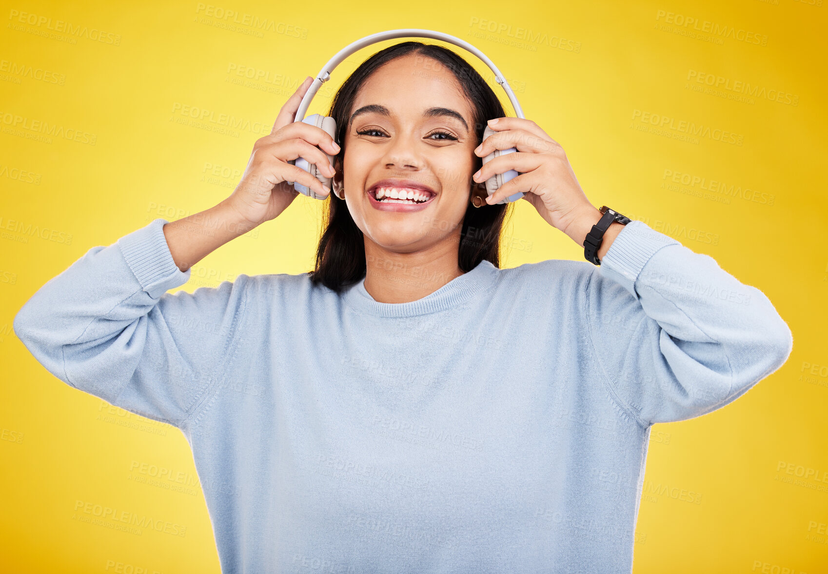Buy stock photo Laugh, music and headphones with portrait of woman in studio for streaming, online radio and audio. Smile, media and podcast with female on yellow background for technology, listening and connection