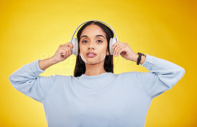 Buy stock photo Music, headphones and portrait of woman in studio for streaming, online radio and audio. Relax, media and podcast with female isolated on yellow background for technology, listening and connection