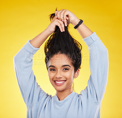 Buy stock photo Young woman, haircare and playful, smile in portrait and hair in air with gen z and fashion on yellow studio background. Happiness, youth and silly Indian female, happy with growth with shine