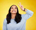 Happy, woman and thinking of peace fingers in studio, background and color backdrop. Female model, v sign and smile with hands for victory, fun mood and happiness of gen z, victory and freedom emoji 