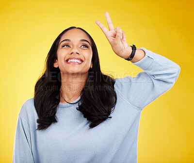 Buy stock photo Happy, woman and thinking of peace fingers in studio, background and color backdrop. Female model, v sign and smile with hands for victory, fun mood and happiness of gen z, vote and freedom of emoji 