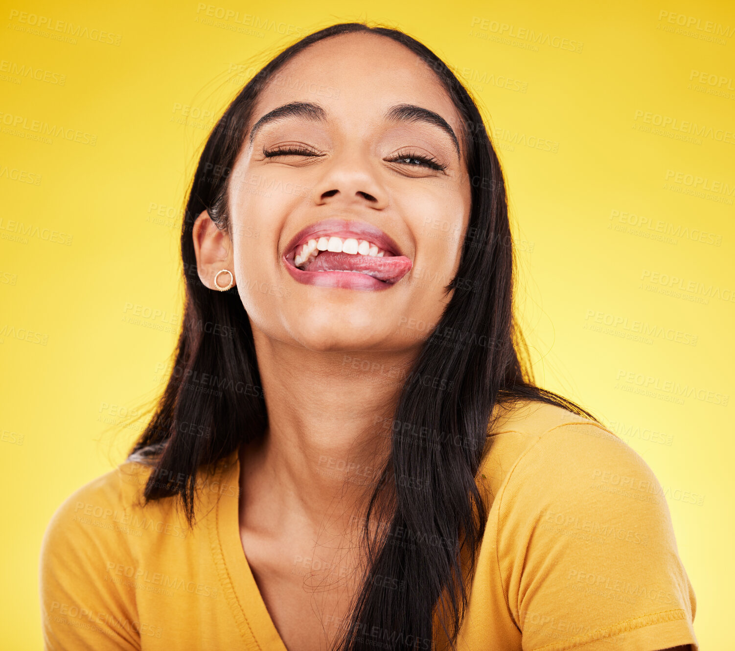 Buy stock photo Woman, portrait smile and tongue out with silly facial expression against a yellow studio background. Happy, fun and goofy carefree female model smiling with teeth and funny face in joyful happiness