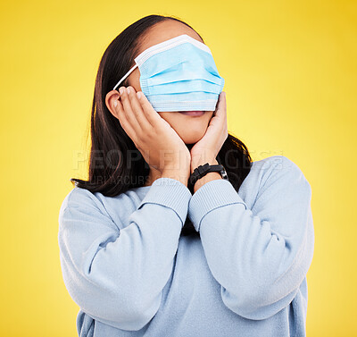 Buy stock photo Covid, face mask and shock with woman and blindfold in studio for medical, crazy and healthcare. Comic, virus and carefree with female on yellow background for vaccine, protection and pandemic