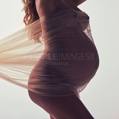 Buy stock photo Woman, pregnancy and fabric with silhouette in studio with hands, touch and art by white background. Pregnant model, shadow and mom wellness with cloth for body, belly or stomach with dark aesthetic