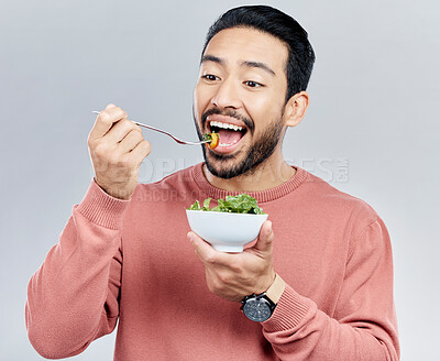 Buy stock photo Man, salad and eating healthy food in studio for health or wellness motivation for vegetables. Asian male vegetable bowl for nutrition, diet and benefits for digestion or lose weight white background