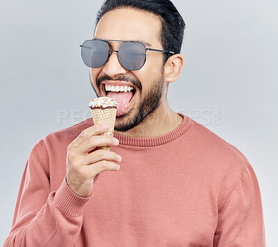 Buy stock photo Ice cream, happy and man in studio with dessert, fun and eating snack against grey background. Cone, sweet and mexican male smile, cheerful and carefree on mockup, space or isolated copy space