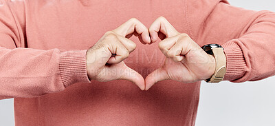 Buy stock photo Man, heart and hands for love in studio to show support, thank you or charity sign language. Male model person with hand icon for kindness, care and hope review, motivation or emoji opinion feedback