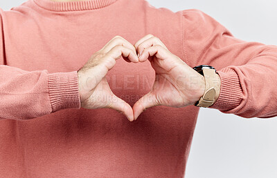 Buy stock photo Heart, man and hands for love in studio to show support, thank you or charity sign language. Male model person with hand icon for kindness, care and hope review, motivation or emoji opinion feedback