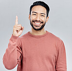 Smile, announcement and portrait of Indian man pointing up, mockup and product placement isolated on white background. Promotion, information and person showing deal space in studio with launch idea.