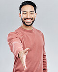 Asian man, portrait smile and handshake for meeting, deal or introduction isolated against white studio background. Happy male smiling and shaking hands for greeting, introduction or friendly gesture